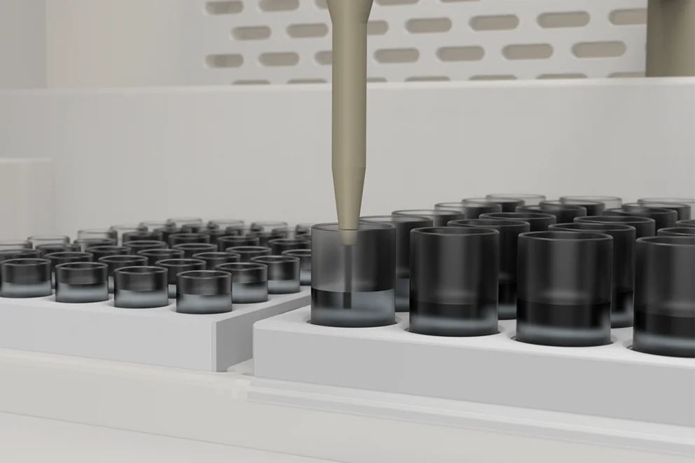 Pipette probe positioned above a black sample vial in an automated laboratory analysis system.