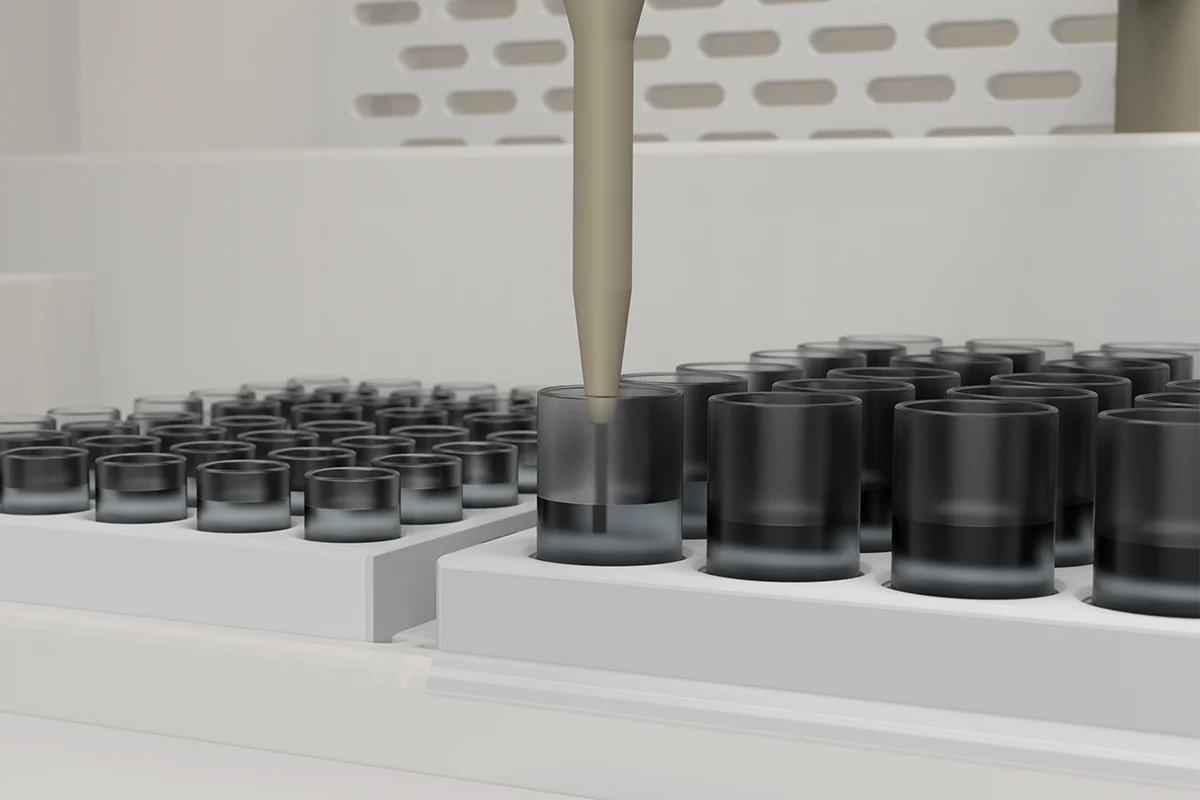 Pipette probe positioned above a black sample vial in an automated laboratory analysis system.
